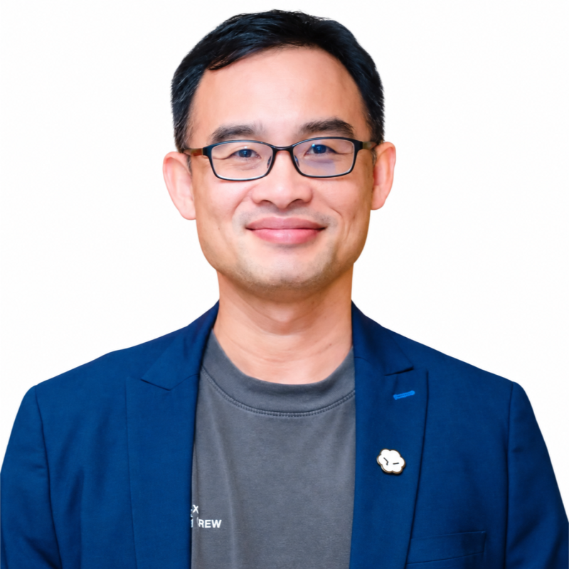 Son Le wearing glasses and a blue blazer